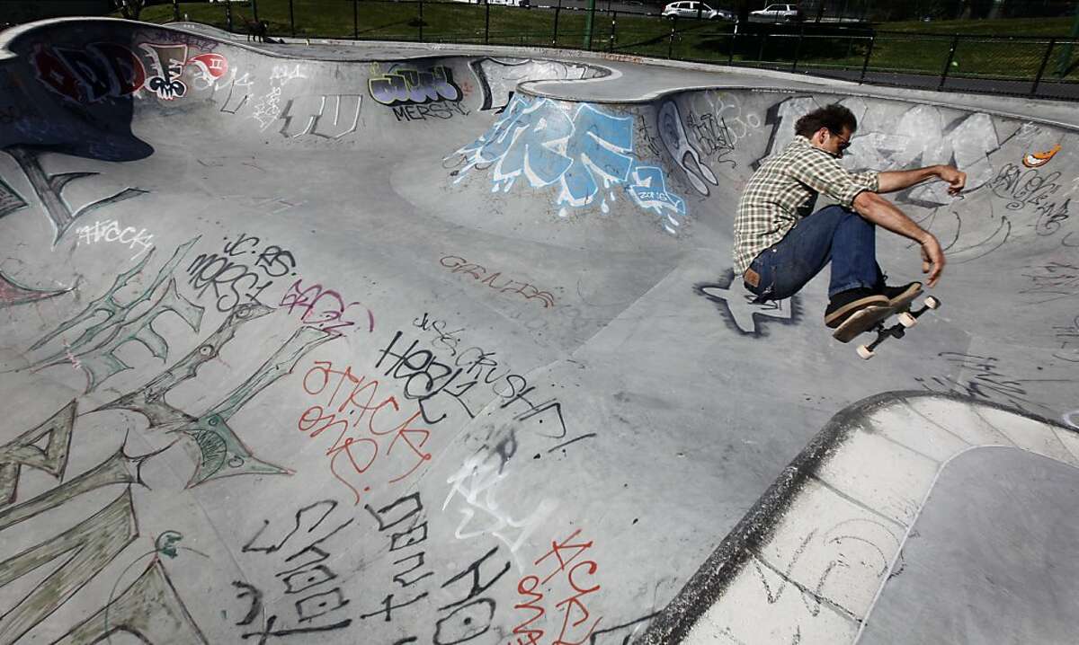 Bob Lake rides his board on the graffiti-covered skateboard park at Potrero del Sol Park in San Francisco, Calif. on Friday, June 1, 2012. The city spends thousands of dollars annually to repair damage to parks caused by vandals.