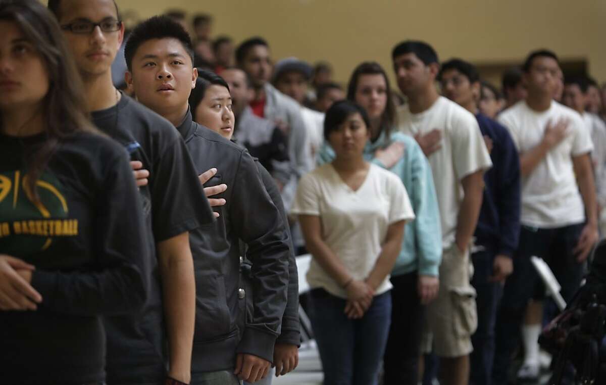 Capuchino High School senior Max Mak (third from left) says the Pledge of Allegiance with other graduating seniors as he attends graduation rehearsal in the gym at Capuchino High School on Wednesday, May 30, 2012 in San Bruno, Calif.