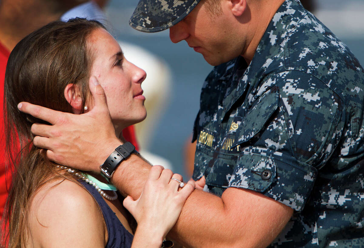 Lt. J.G. Michael Brown of Virginia Beach, Va., says goodbye to his fiancee, Lauren Ervin of Virginia Beach on the pier at the Norfolk Naval Station in Norfolk, Va., Friday morning, June 1, 2012 before the guided-missile frigate Carr deploys.