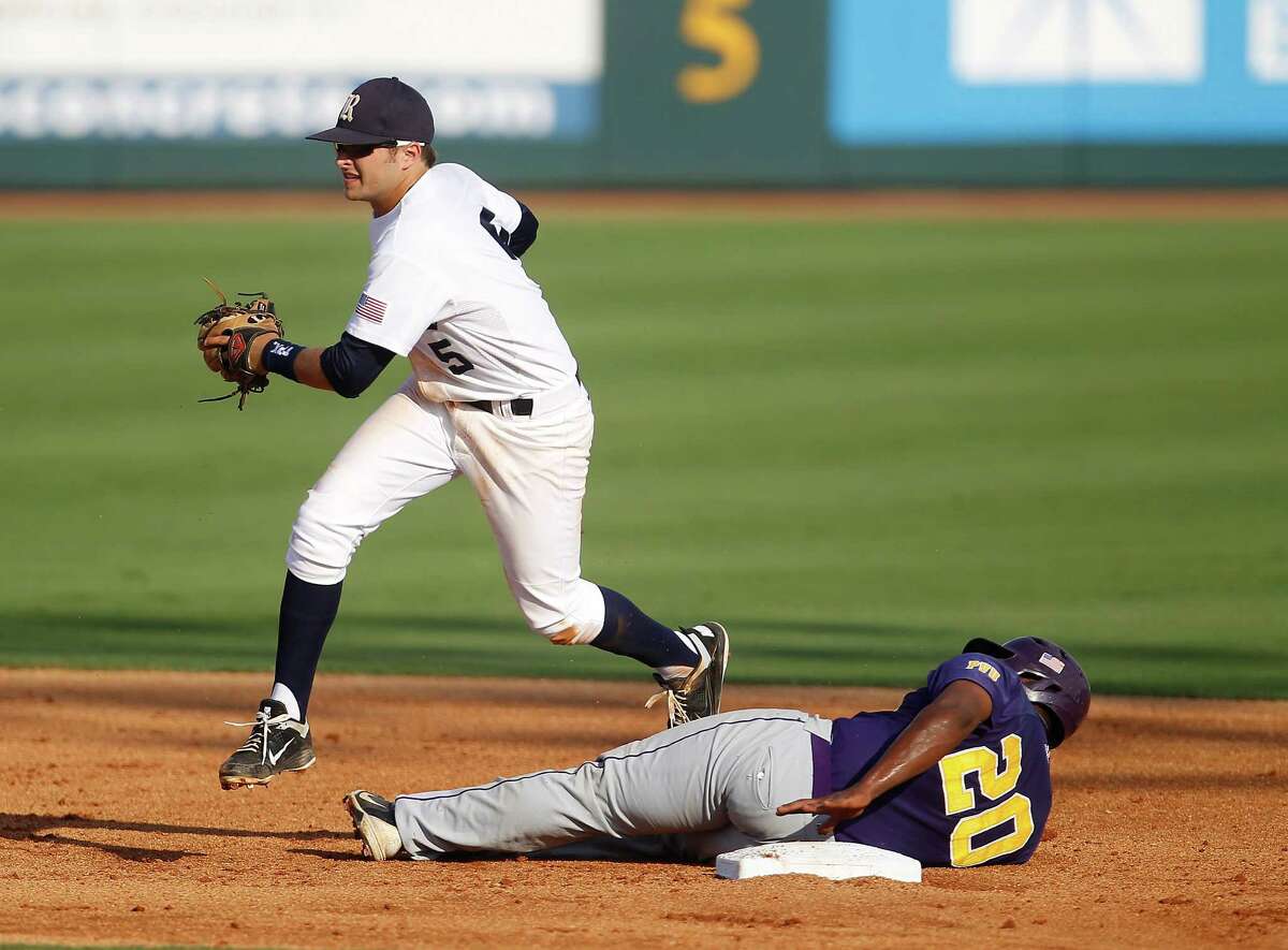 Prairie View's Evan Richard (20) lies on second base safely after a throwing error as Rice's Christian Stringer (5) tries to tag him in the 2nd inning during a college baseball game at the Houston Regional at Rice University, Friday, June 1, 2012, in Houston. Rice won the game 3-2.