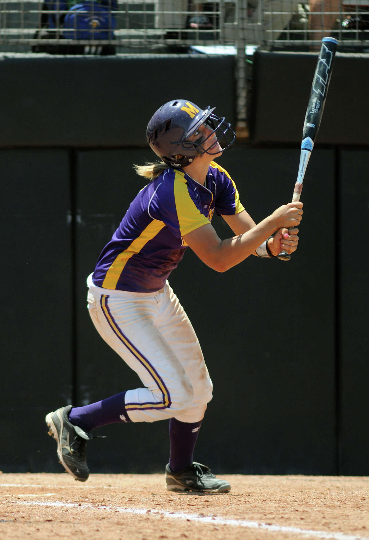 Montgomery sophomore third baseman Malloree Schurr follows her drive during her at-bat in the bottom of the 2nd inning against Smithson Valley during their 4A state softball final at Red & Charline McCombs Field in Austin on Saturday.