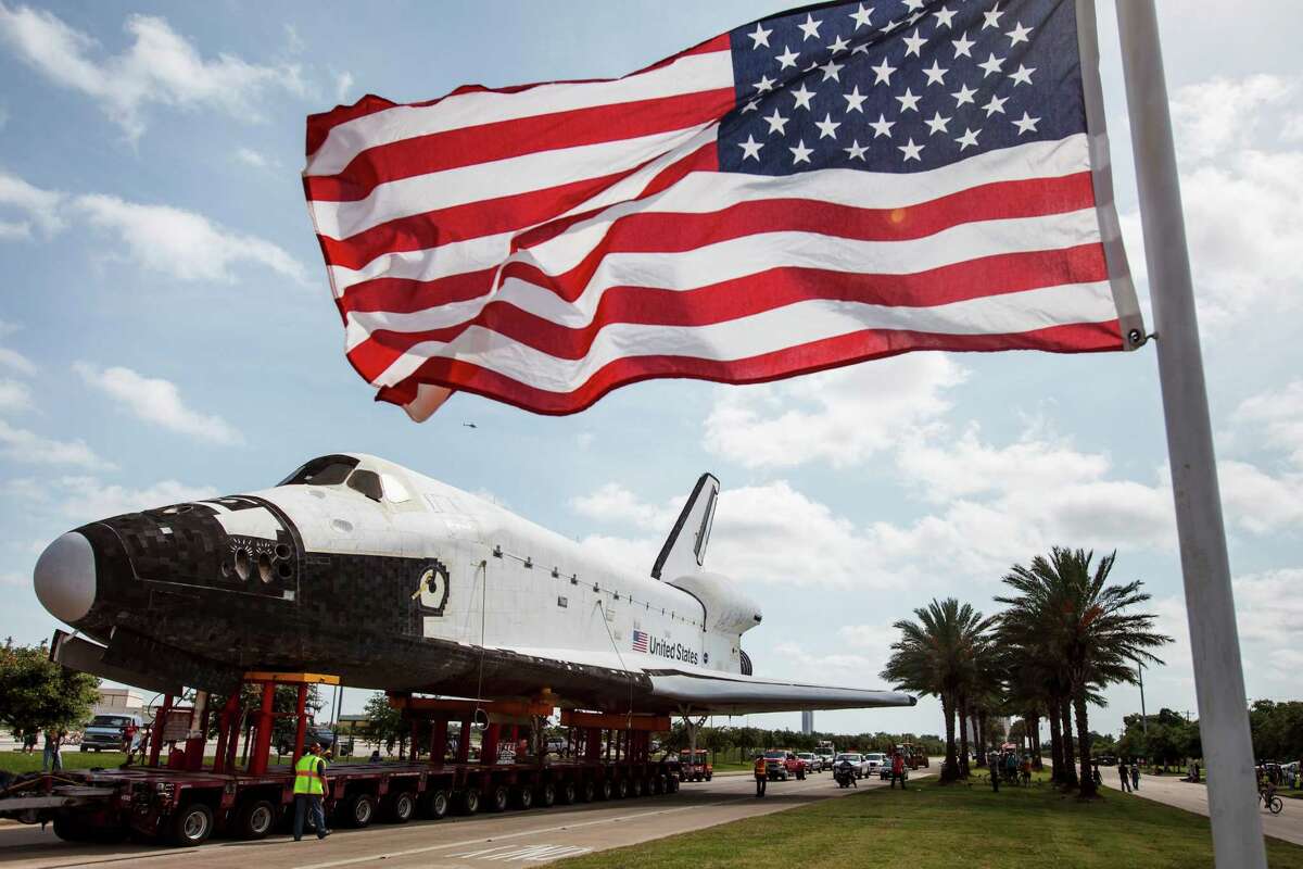 A full-size replica of the space shuttle is slowly moved down Nasa Road 1 to Space Center Houston, Sunday, June 3, 2012, in Houston. The mock-up shuttle Explorer arrived by barge from the Kennedy Space Center to its new home at Space Center Houston.