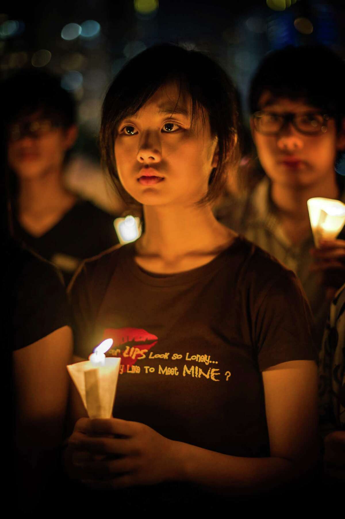 A girl holds a candle during a candlelight vigil in Hong Kong on June 4, 2012 held to mark the crackdown on the pro-democracy movement in Beijing's Tiananmen Square in 1989. Hundreds, perhaps thousands, are believed to have died when the government sent in tanks and soldiers to clear Tiananmen Square, bringing a violent end to six weeks of pro-democracy protests. AFP PHOTO / Philippe LopezPHILIPPE LOPEZ/AFP/GettyImages