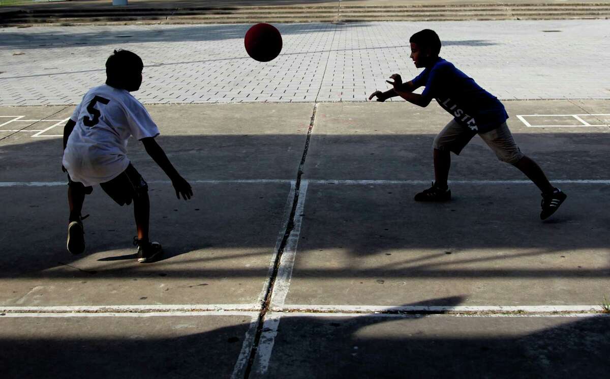 Vincent Trevino and Miguel Cisneros play early in the morning while enrolled in the Summer Enrichment Program at Eastwood Park on Monday, June 4, 2012, in Houston.