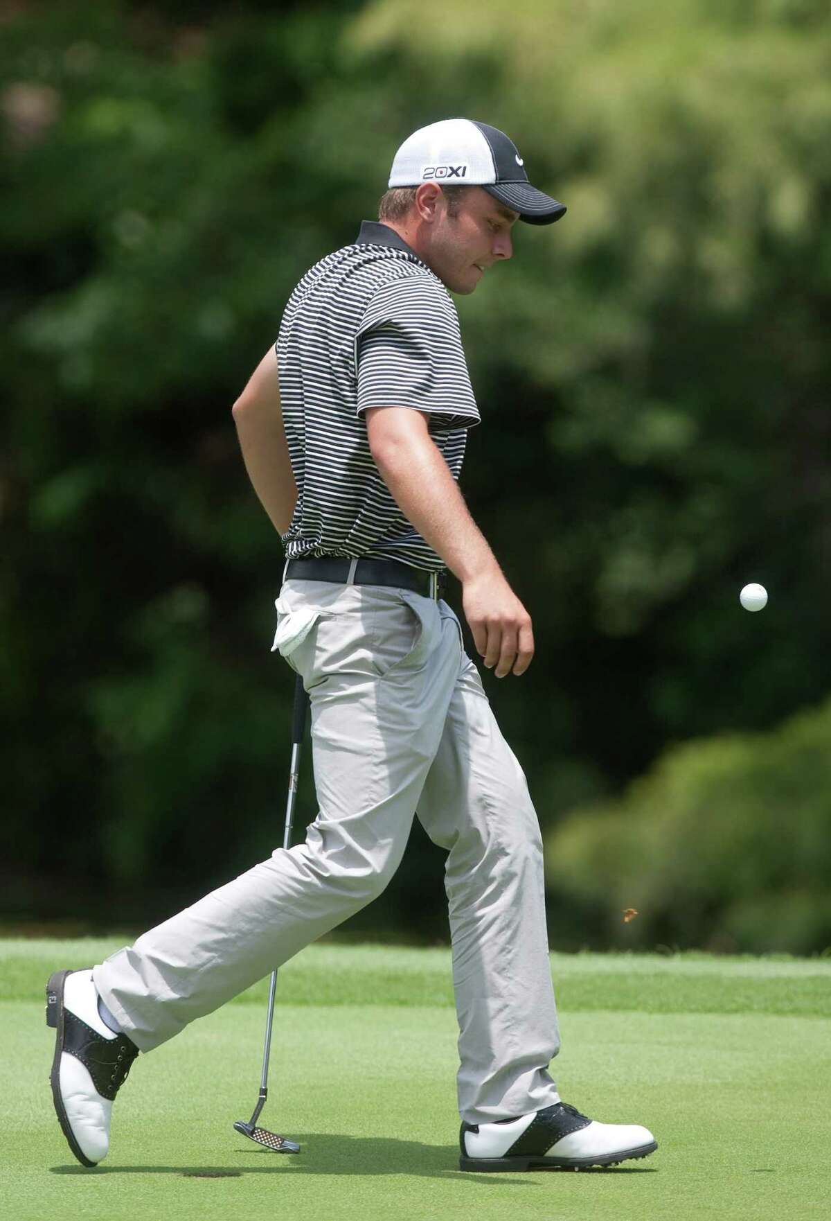 Austin Quick kicks his ball after missing a birdie putt and settling for par on hole eighteen during the U.S. Open sectional qualifying tournament at Lakeside County Club on Monday, June 4, 2012 in Houston, Texas.