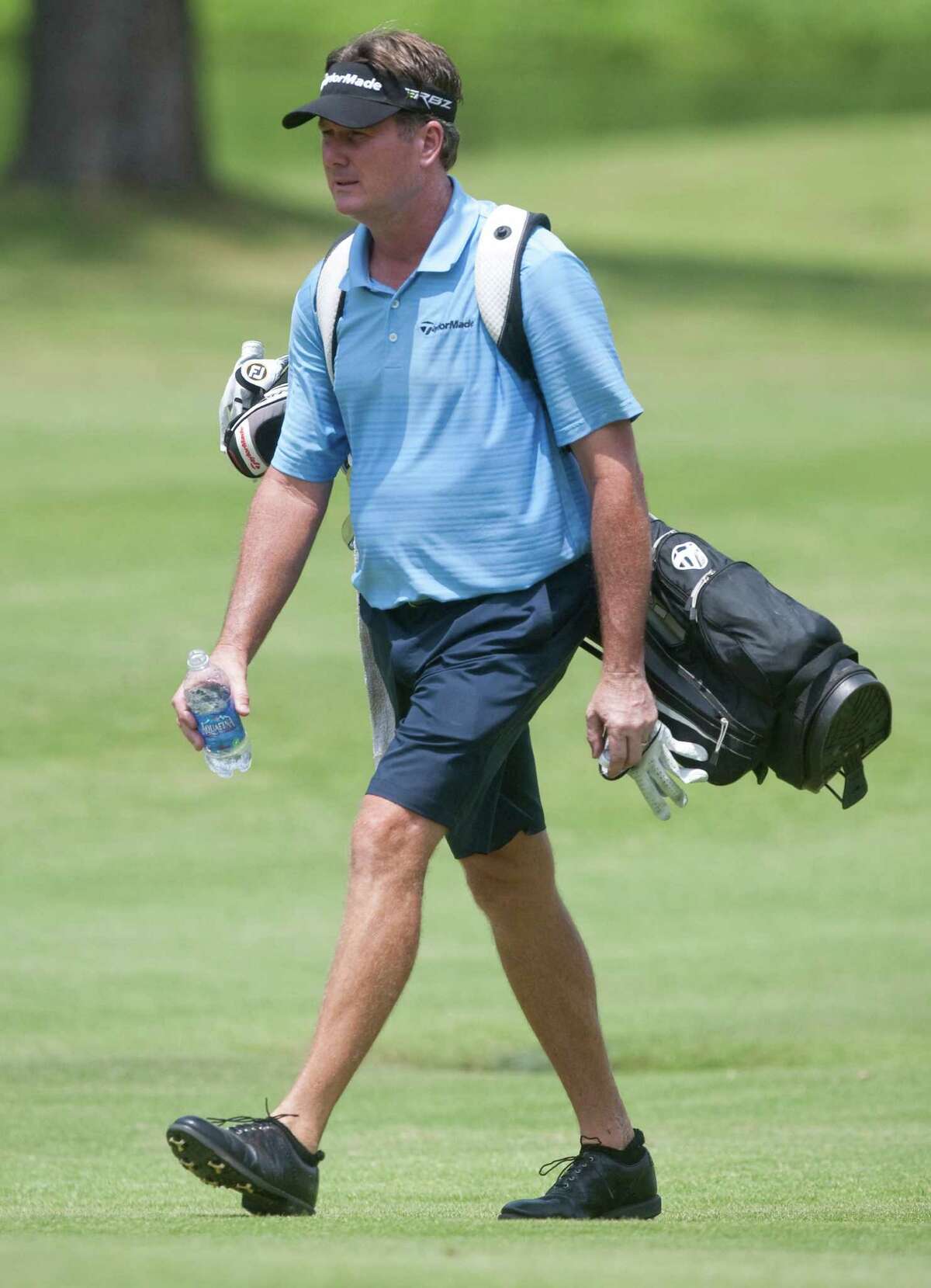 Todd Hamilton carries his own bags on hole sixth during the U.S. Open sectional qualifying tournament at Lakeside County Club on Monday, June 4, 2012 in Houston, Texas.