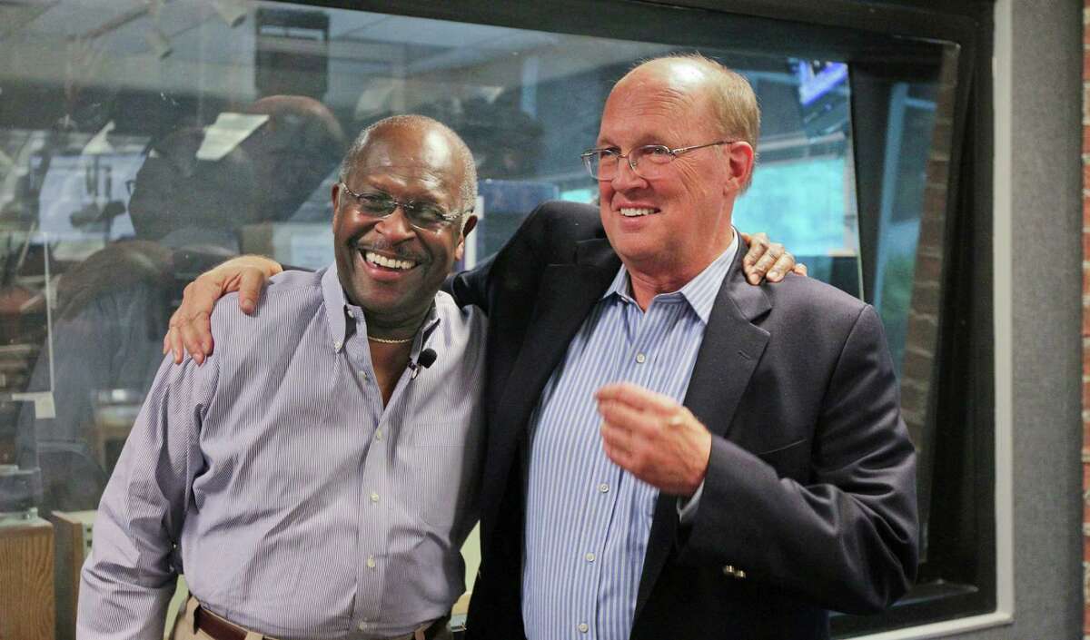 Herman Cain congratulates Neal Boortz, right, on his retirement announcement after the pair went on the WSB radio together Monday in Atlanta.