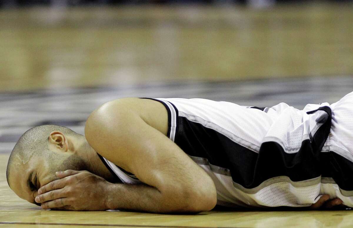 San Antonio Spurs' Tony Parker (9), of France, reacts after taking a hit to the face against the Oklahoma City Thunder during the second half of Game 5 in the NBA basketball Western Conference finals, Monday, June 4, 2012, in San Antonio. The Thunder won 108-103. (AP Photo/Eric Gay)
