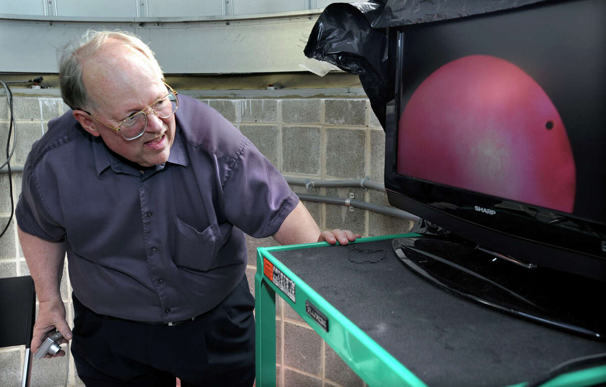 Dennis Dawson, professor of astronomy at Western Connecticut State University, gets a look at the Transit of Venus, televised on a monitor at the observatory on the roof of the Science Building at Western Connecticut State University, Tuesday, June 5, 2012.