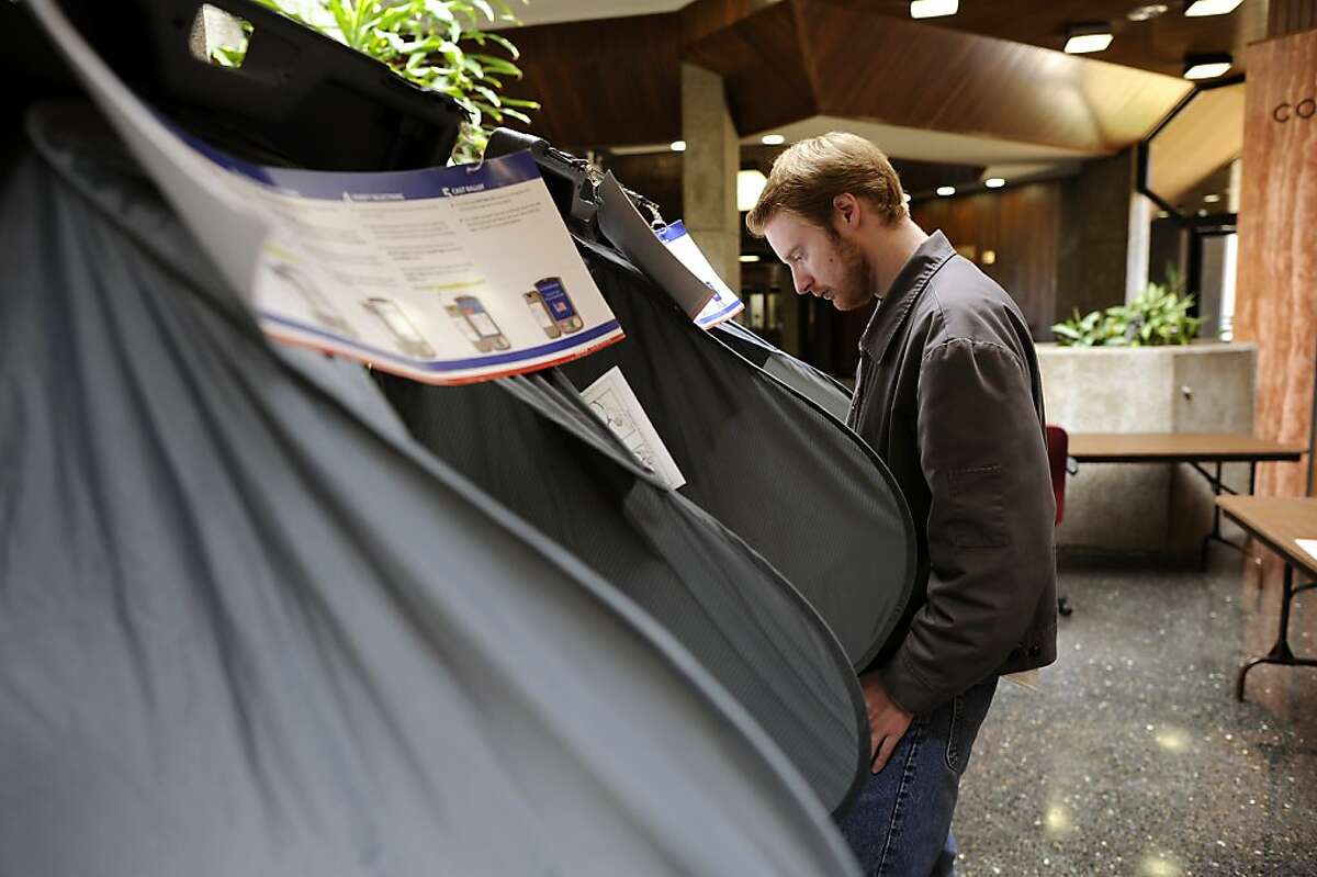 Jonathan Stockhus stands at a voting machine as he casts his vote at City Hall in Daly City. California held it's primary election June 5th, 2012.