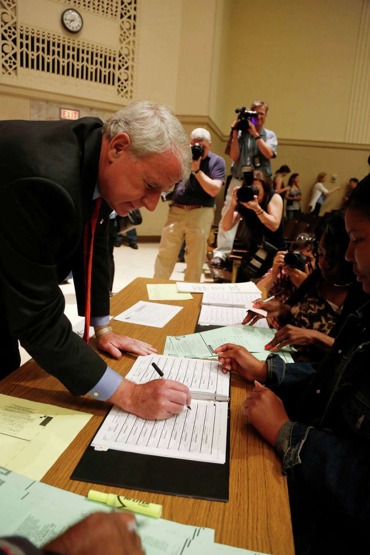 Wisconsin Democratic gubernatorial candidate Tom Barrett signs his name to get his ballot Tuesday, June 5, 2012, in Milwaukee. Barrett is facing Republican Wisconsin Gov. Scott Walker in a recall election. (AP Photo/Jeffrey Phelps)