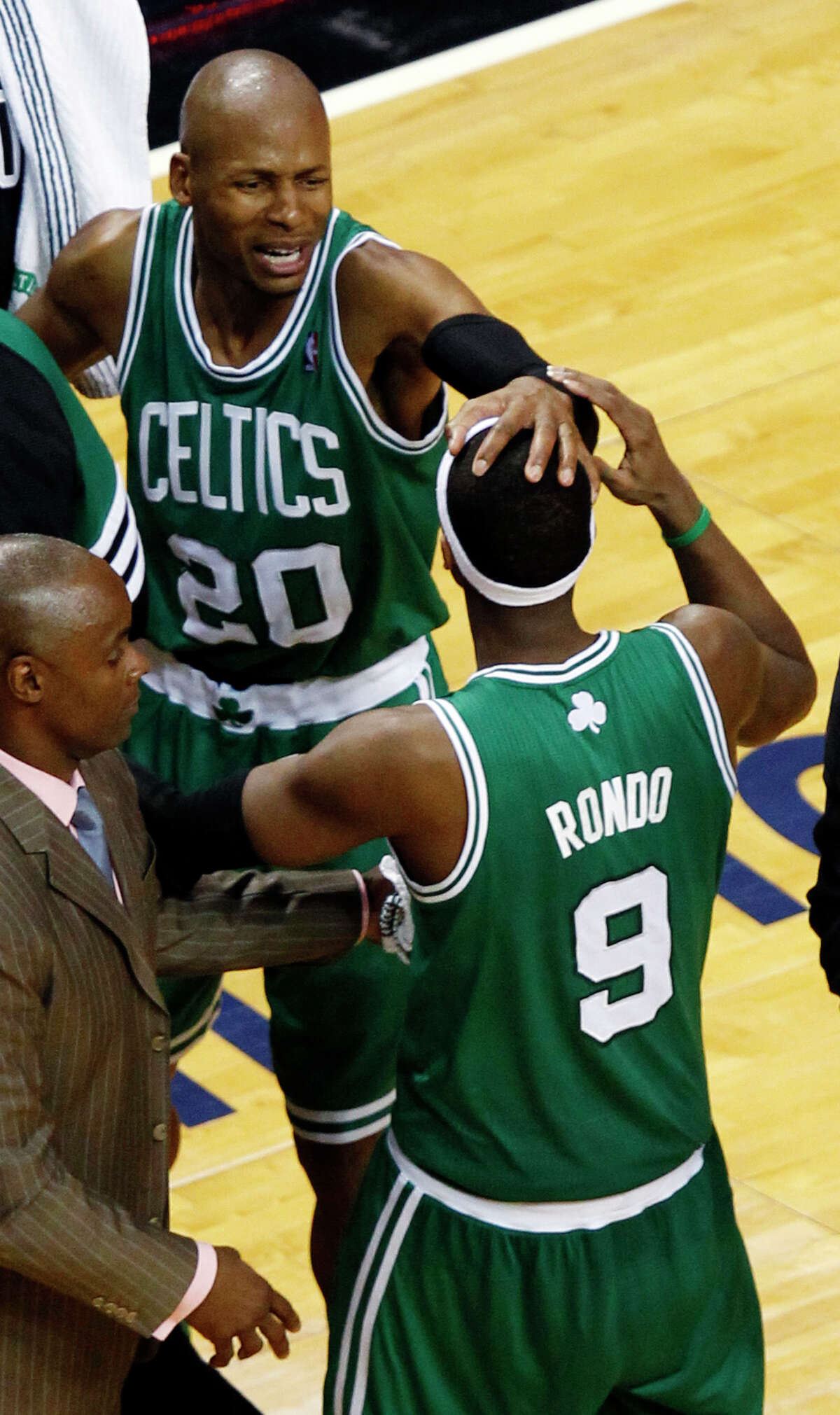 Boston Celtics' Ray Allen (20) congratulates Rajon Rondo (9) during the second half of Game 5 in their NBA basketball Eastern Conference finals playoffs series against the Miami Heat, Tuesday, June 5, 2012, in Miami. The Celtics won 94-90. (AP Photo/Wilfredo Lee)