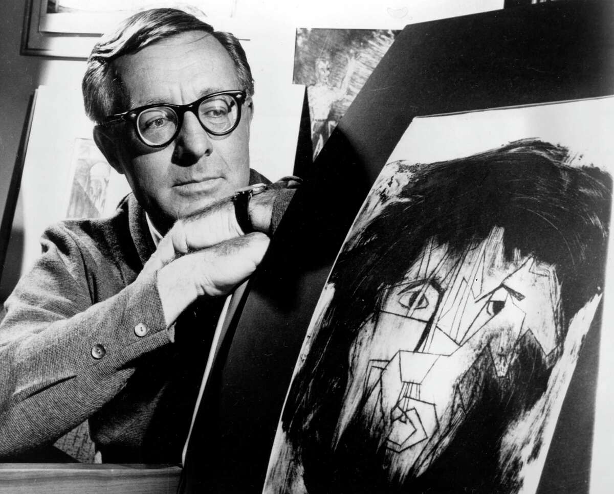 This Dec. 8, 1966 file photo shows science fiction writer Ray Bradbury looking at a picture that was part of a school project to illustrate characters in one of his dramas in Los Angeles. Bradbury, who wrote everything from science-fiction and mystery to humor, died Tuesday, June 5, 2012 in Southern California. He was 91. (AP Photo, file)