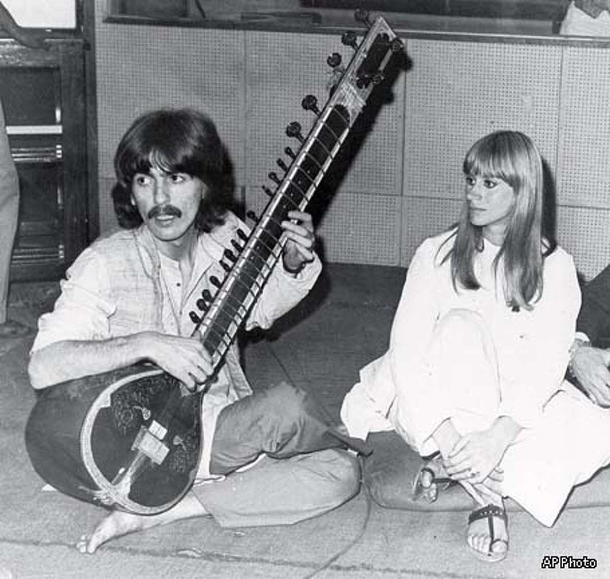 FILE--George Harrison plays the sitar in Bombay, India in this Jan. 14, 1968, file photo. Harrison died Thursday Nov. 29, 2001, a longtime family friend said. He was 58. At right is British actress Rita Tushingham, who was making a motion picture in India. (AP Photo)