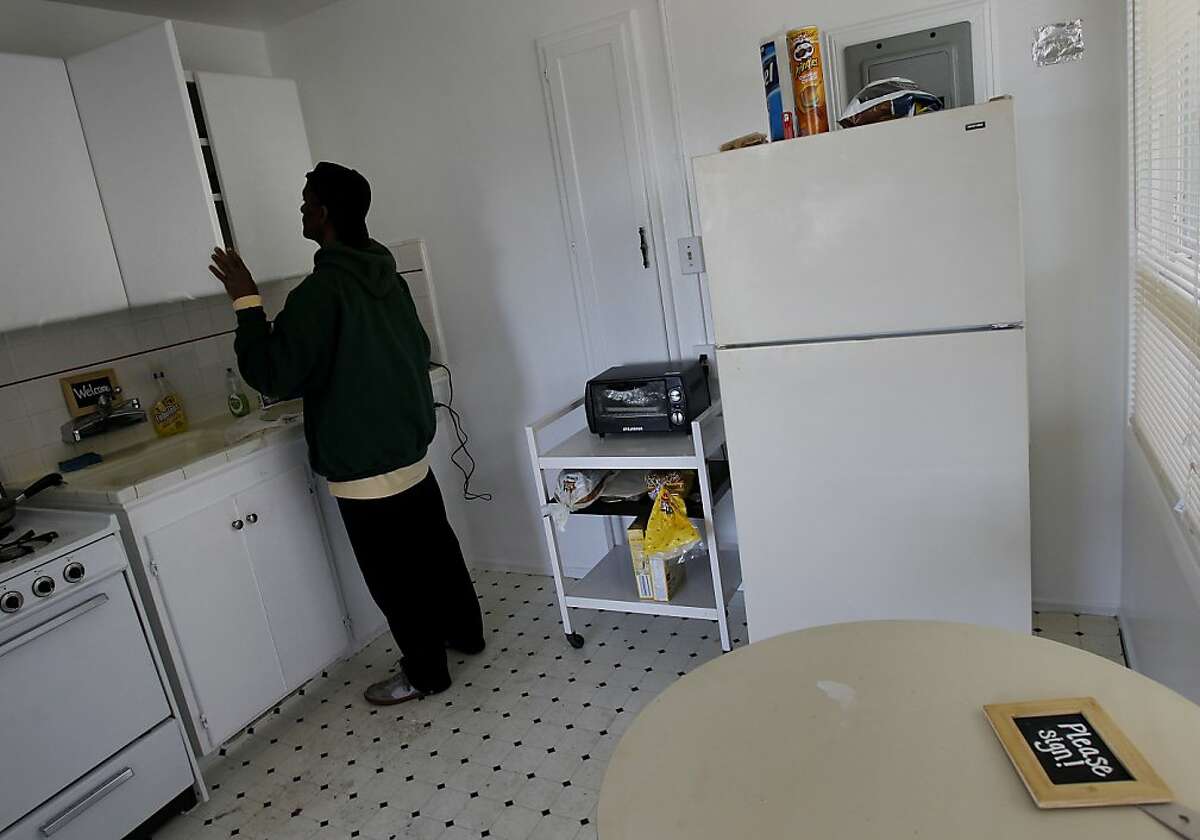 Brett Smith searches for a water glass in his apartment. Brett Smith, a U.S. Army veteran, was homeless in San Francisco for years, but now has a place in the Richmond district not far from the beach.
