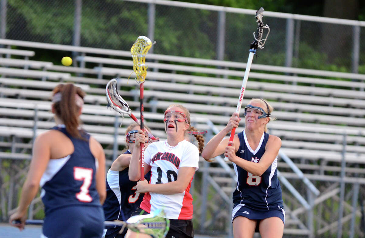 New Canaan's Sarah Mannelly (10) takes a shot as New Fairfield's Brittany Muratore (3) and Dana Bouwman (8) defend during the girls lacrosse Class M semifinals at Bunnell High School in Stratford on Wednesday, June 6, 2012.