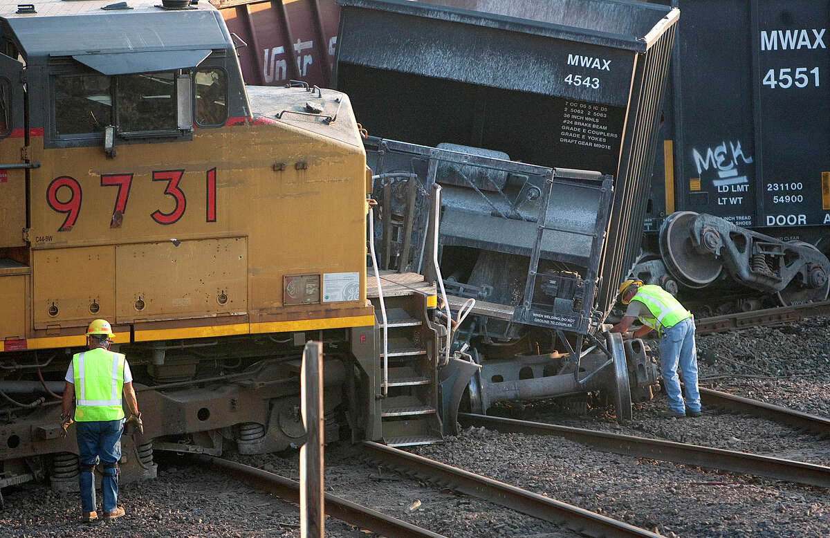 Crews work the scene of a train accident after cars derailed at the intersection of Liberty Road and N Wayside Drive Thursday, June 7, 2012, in Houston.