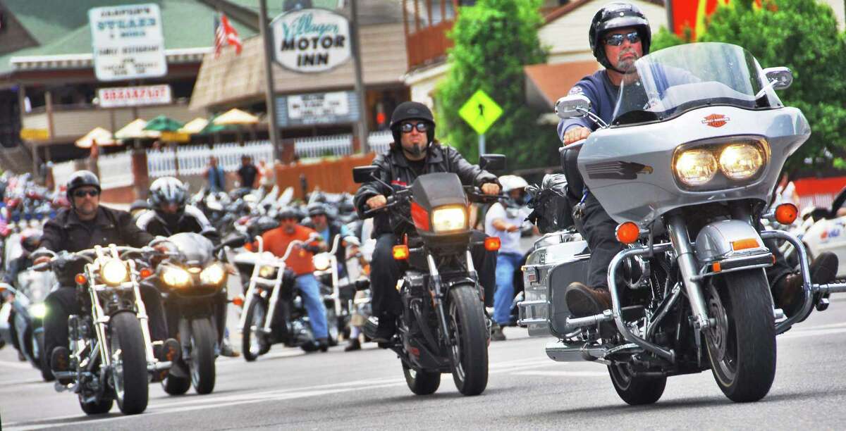 The flash of chrome and the roar of engines mark the return of the annual Americade as thousands of motorcyclists, including this group heading up Canada Street, pour into Lake George Village Thursday June 5, 2008. 
