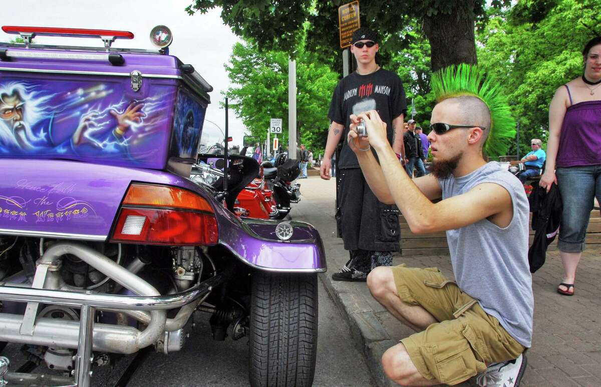 Nate Baldwin of Rindge, N.H., photographs custom artwork on a three-wheeled motorcycle on Canada Street as the annual Americade brings thousands of motorcyclists into Lake George Village Thursday June 5, 2008. 