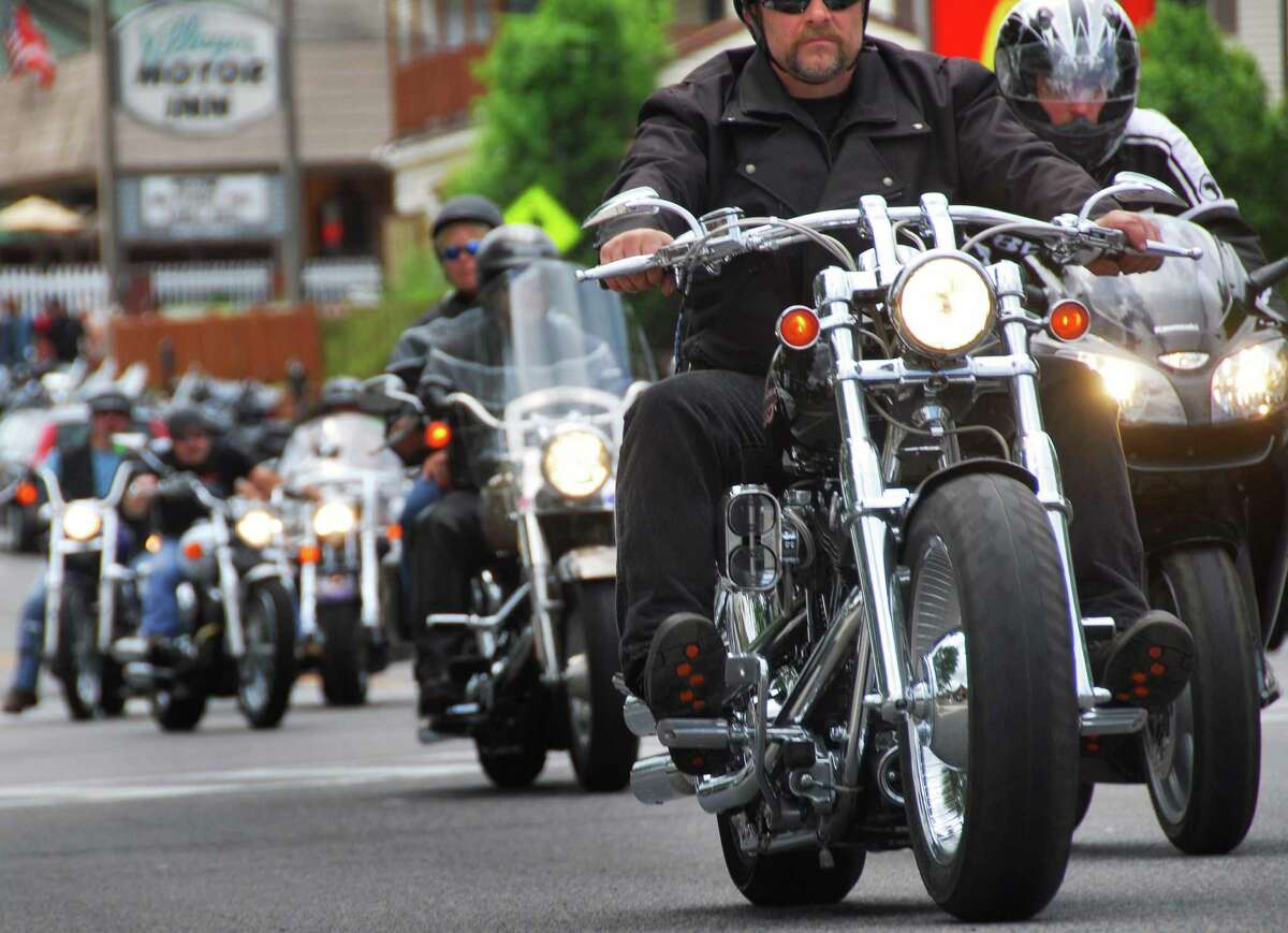 The flash of chrome and the roar of engines mark the return of the annual Americade as thousands of motorcyclists, including this group heading up Canada Street, pour into Lake George Village Thursday June 5, 2008.