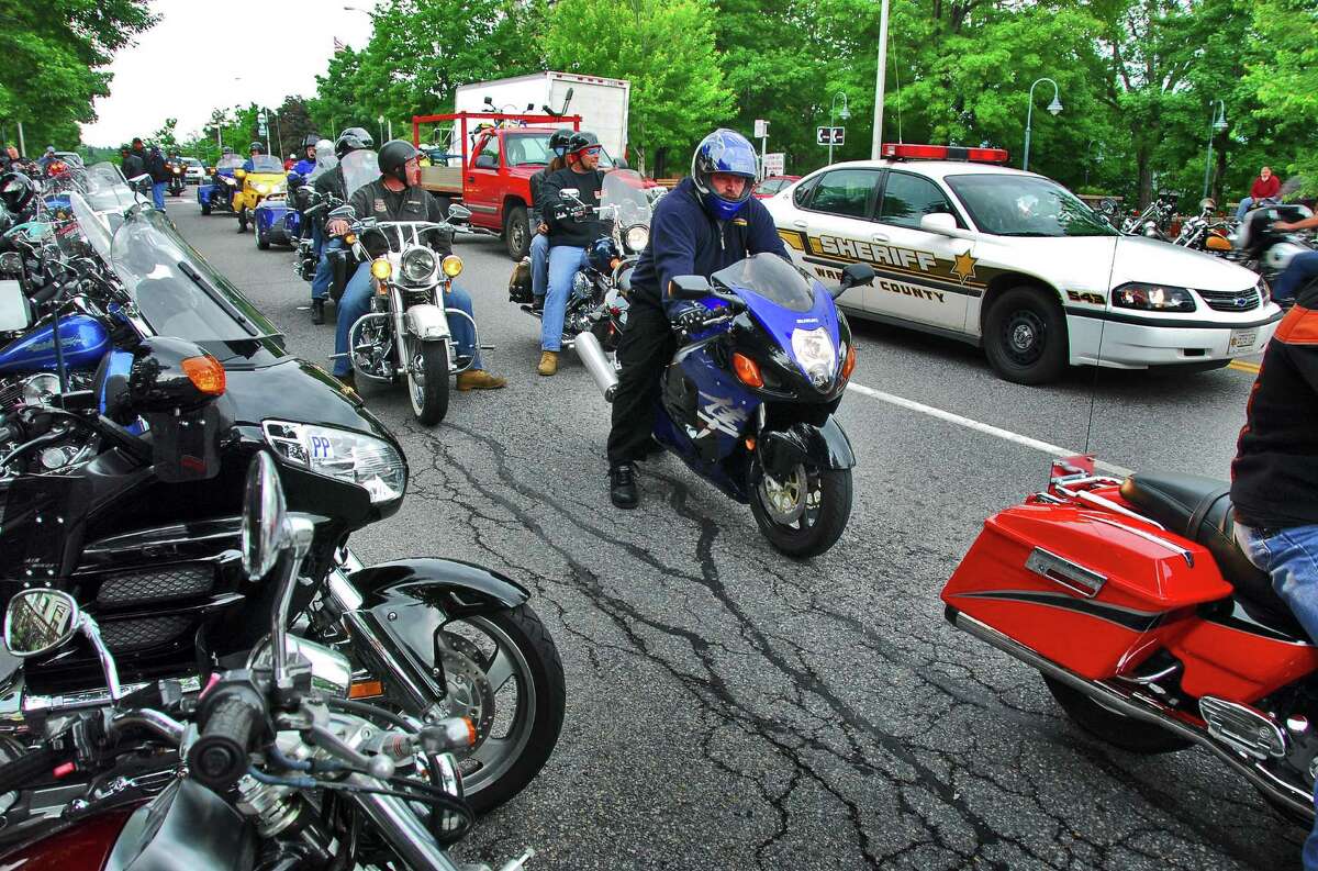 A Warren County Sheriff's car shares Canada Street with motorcyclists in Lake George Village Thursday afternoon June 8, 2006, for annual Americade weekend.