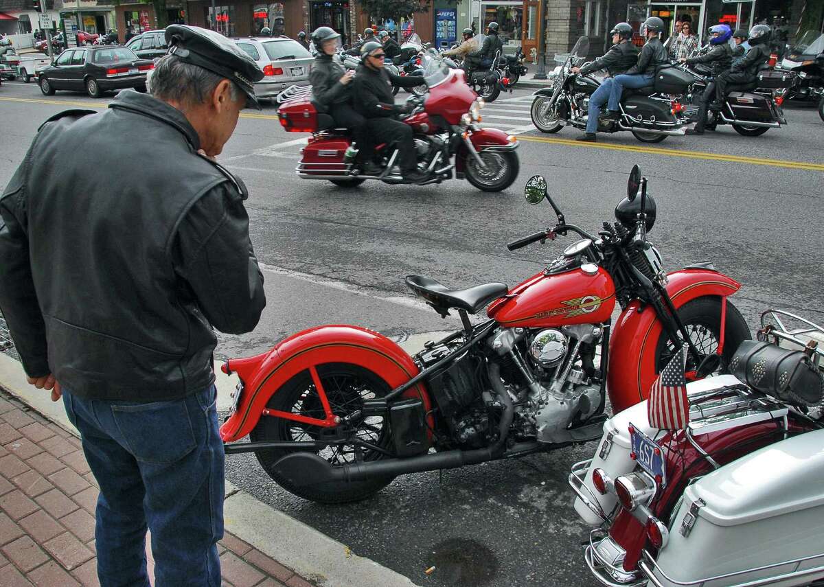 Times Union staff photo by John Carl D'Annibale Conrad Marzano of Orange, NJ, looks over a Depression Era Harley Davidson "knuckle head" parked on Canada St., as motorcyclists pour into Lake George Village Thursday afternoon June 8, 2006, for annual Americade weekend.