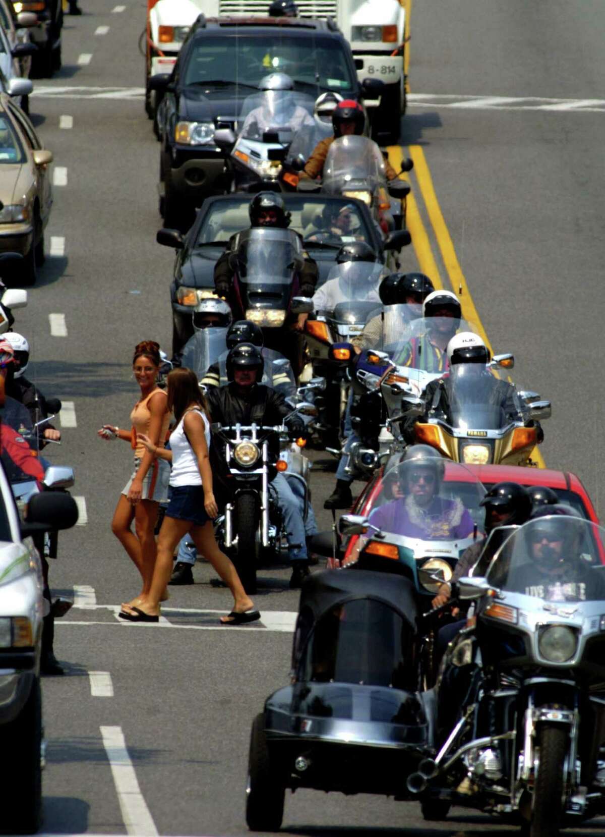 Pedestrians cross Canada Street in Lake George, NY between motorcycle riding attendees of Americade Monday June 7, 2004.