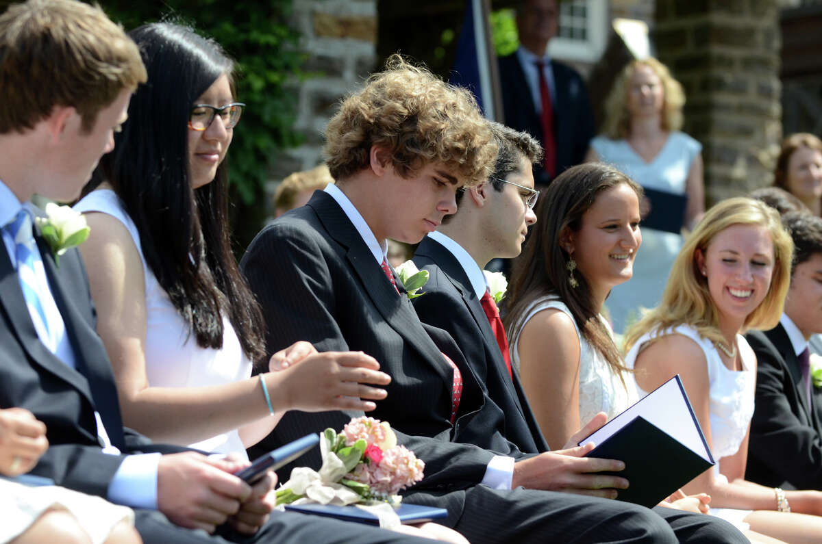 Graduate Thatcher Cleason, of Darien, looks at his diploma during the Greens Farms Academy senior graduation in Westport on Thursday, June 7, 2012.