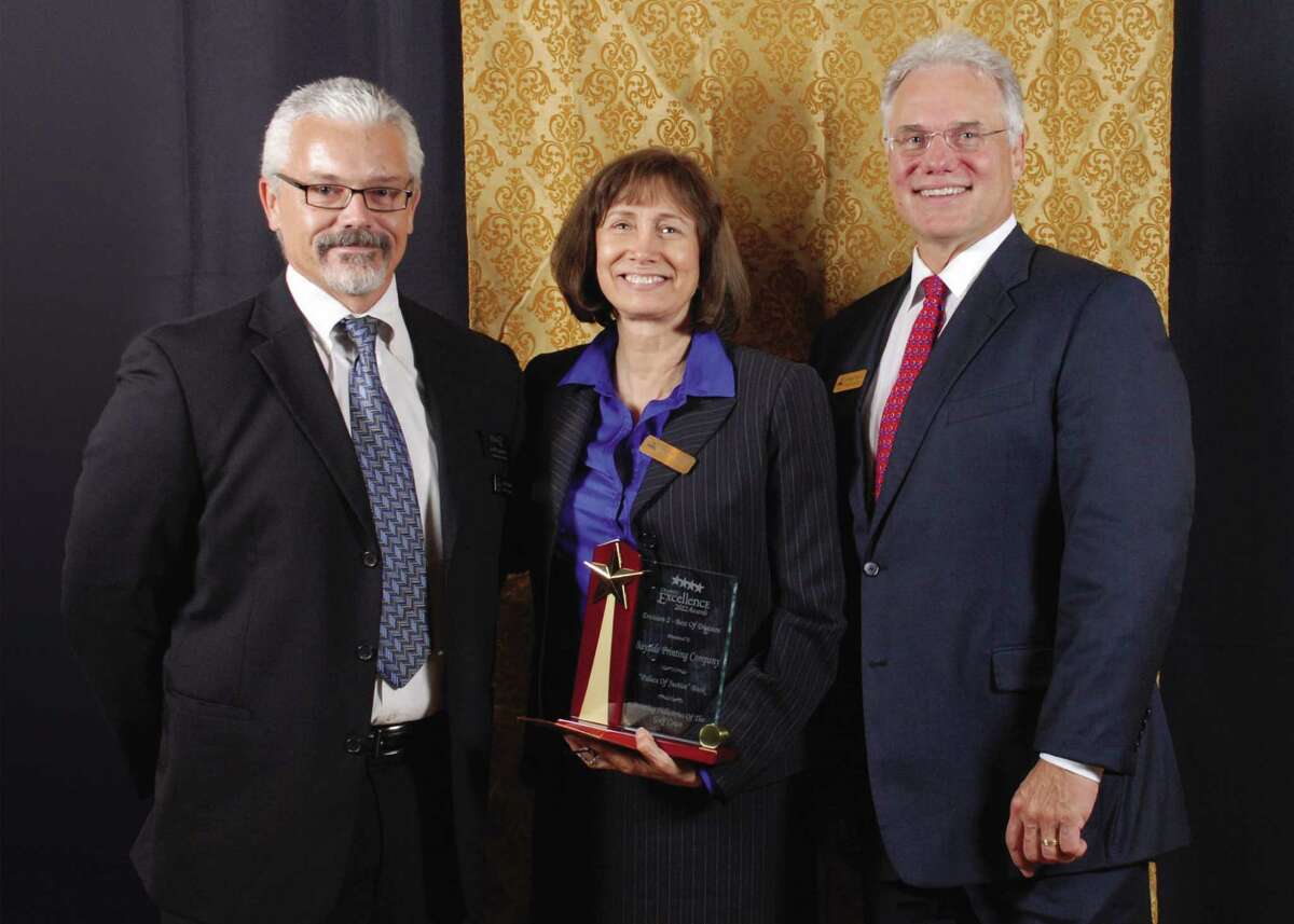Rose Mary Bundscho, owner of Bayside Printing, receives the Printing Industries Gulf Coast "Best of Show" award for 2012 and "Best of Division II" from PRISCO’s Jeff Sadler (left) and Gregg Parnell at the recent 2012 Graphic Excellence Awards Gala.