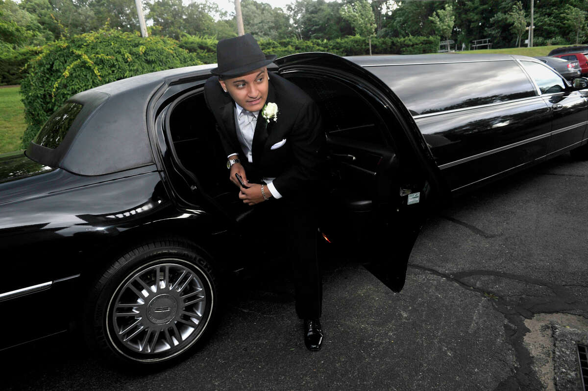 Elijah Montalvo exits a limo after arriving at the Henry Abbott Technical High School Senior Prom at the Candlewood Inn in Brookfield, Conn., on Thursday, June 7, 2012.