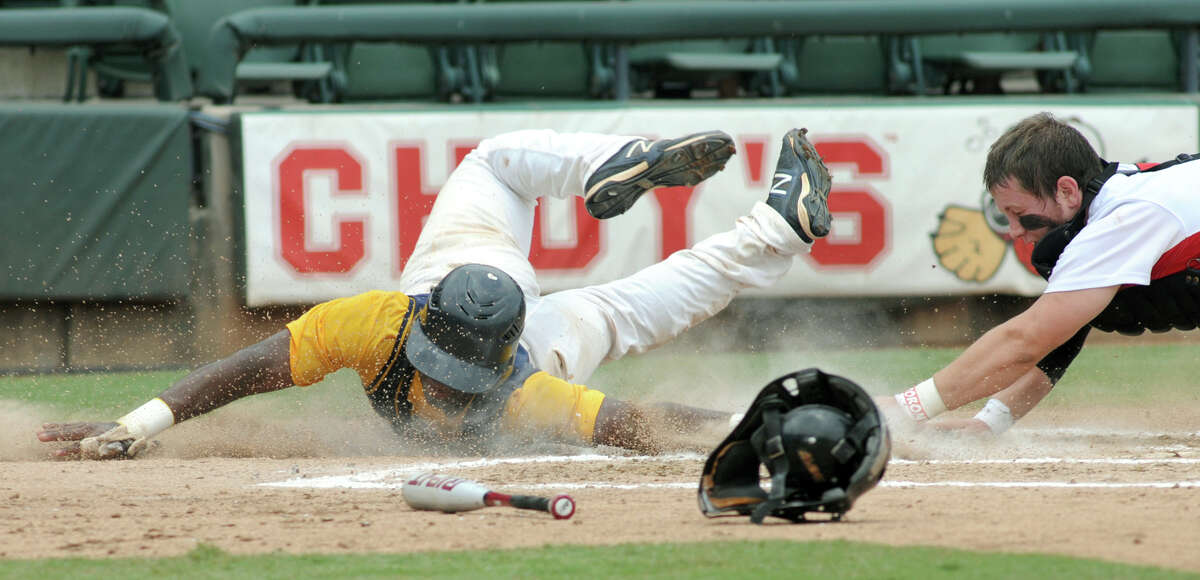 Cy-Ranch senior shortstop Leon Byrd slides safely around the tag of Arlington Martin catcher Collin Lawrence in the top of the third inning of their Class 5A Semi-final versus Arlington Martin at the 2012 UIL State Baseball Championships at Dell Diamond in Round Rock on Friday.