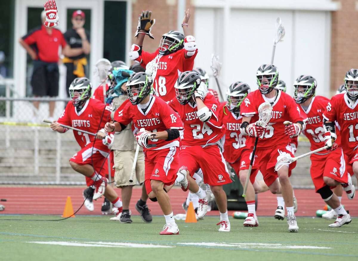 The Fairfield Prep lacrosse team runs out on the field to celebrate their 8-6 victory over Ridgefield in the Class L Final lacrosse championship at Brien McMahon High School on Saturday June 9, 2012.