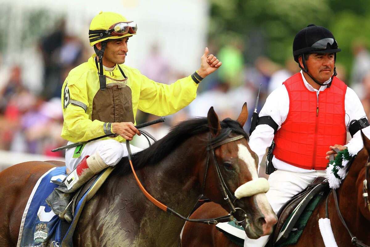 ELMONT, NY - JUNE 09: John Velasquez, Jockey of Union Rags celebrates his victory during the 144th running of the Belmont Stakes at Belmont Park on June 9, 2012 in Elmont, New York.