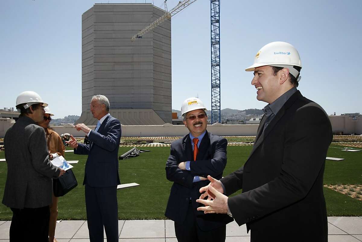 San Francisco Mayor Ed Lee, center, and Twitter CFO Ali Rowghani, right, tour the rooftop garden at the SF Furniture Mart building, which is under renovations to become Twitter's offices in San Francisco, Calif., Thursday, May 10, 2012. One of Mayor Lee's first policy decisions was pushing a tax break for the downtrodden Mid-Market area to keep Twitter Inc. from leaving the city.