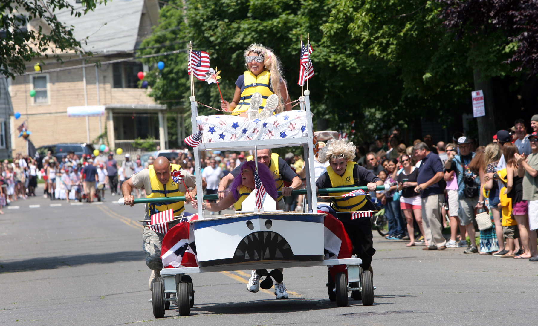 Beds race down Brewster Street at Black Rock Day celebration