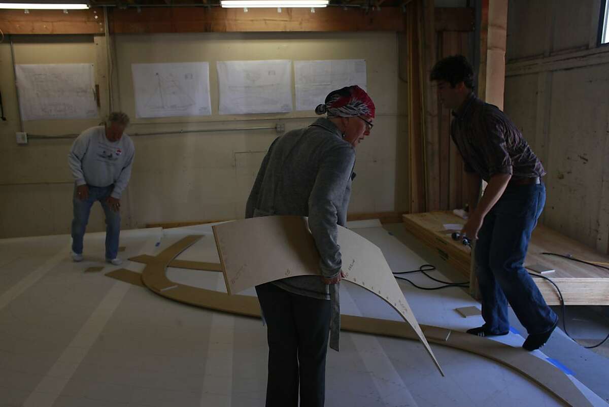 Members the nonprofit Educational Tall Ships, Chris Burke, Kim Kouri and Sam Schow work together the map out the beginnings of a new tall ship called a Brigantine on Wednesday June 6, 2012 in Sausalito, Calif. The group expects the process of building ship to take 18 months.