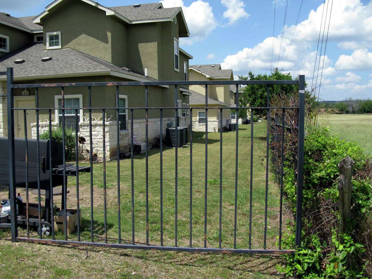 A metal fence blocks the access easement that runs along the side of the Stone Creek Village Apartments in Boerne.