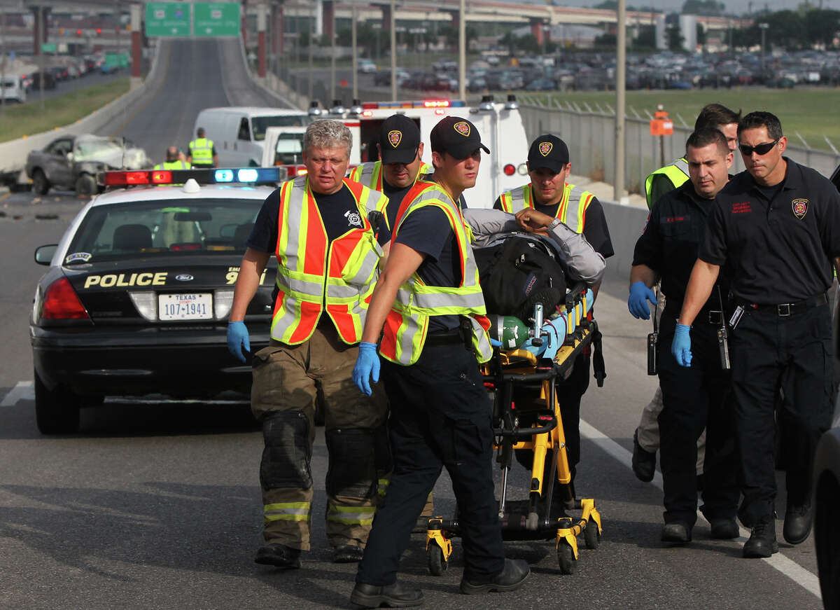 San Antonio firefighters remove Dirck Gillam,26, from the scene of a fatal accident that took place Monday June 11, 2012 shortly after 7:00 a.m. on a westbound portion of Loop 410 between Wetmore road and Airport Boulevard.