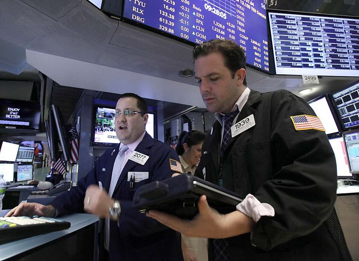 Specialist Brian Fairbrother, left, and trader Christopher Lotito work on the floor of the New York Stock Exchange Monday, June 11, 2012. Stocks are opening higher on Wall Street, following markets higher across the globe after European countries said they would lend Spain as much as $125 billion to save its banks. (AP Photo/Richard Drew)