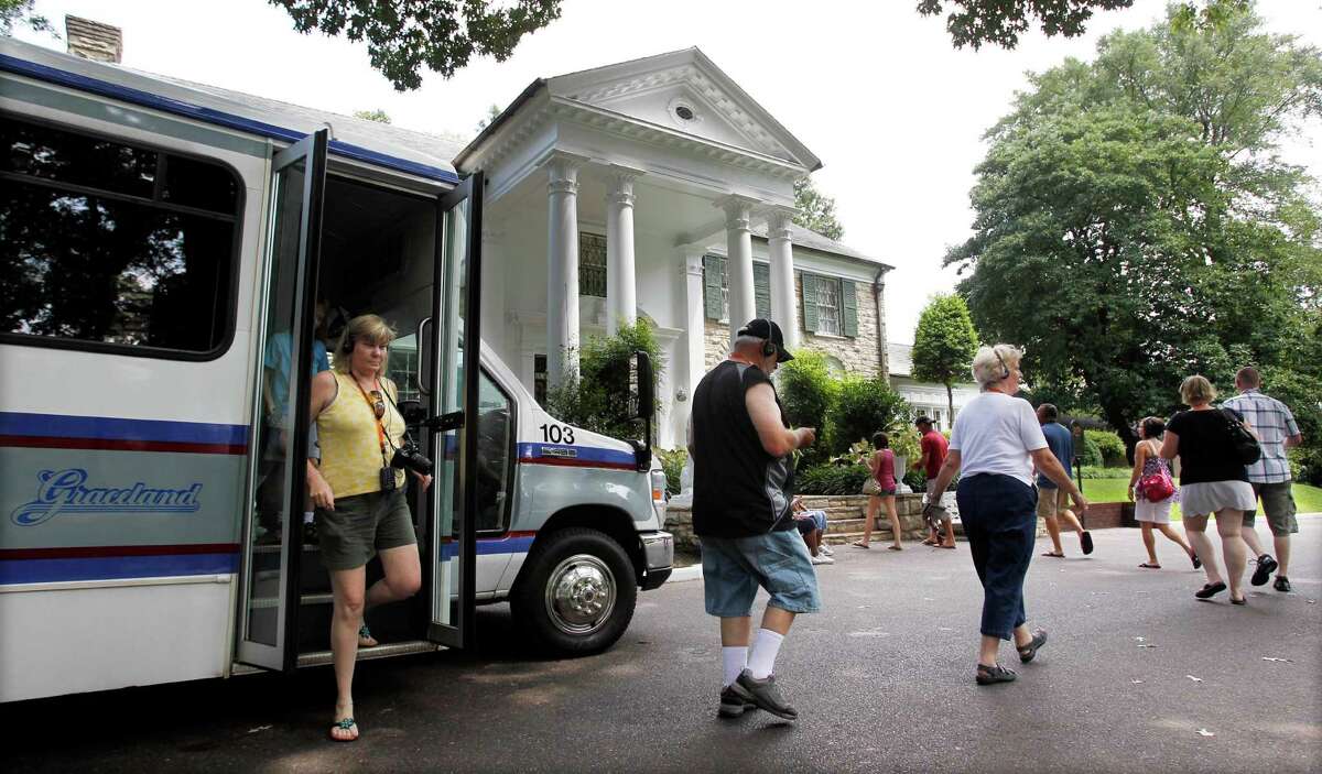 FILE -- This Aug. 2010 photo shows tourists arriving at Graceland, Elvis Presley's home in Memphis, Tenn. Graceland opened for tours on June 7, 1982. They sold out all 3,024 tickets on the first day and didn't look back, forever changing the Memphis tourist landscape while keeping Elvis and his legend alive.