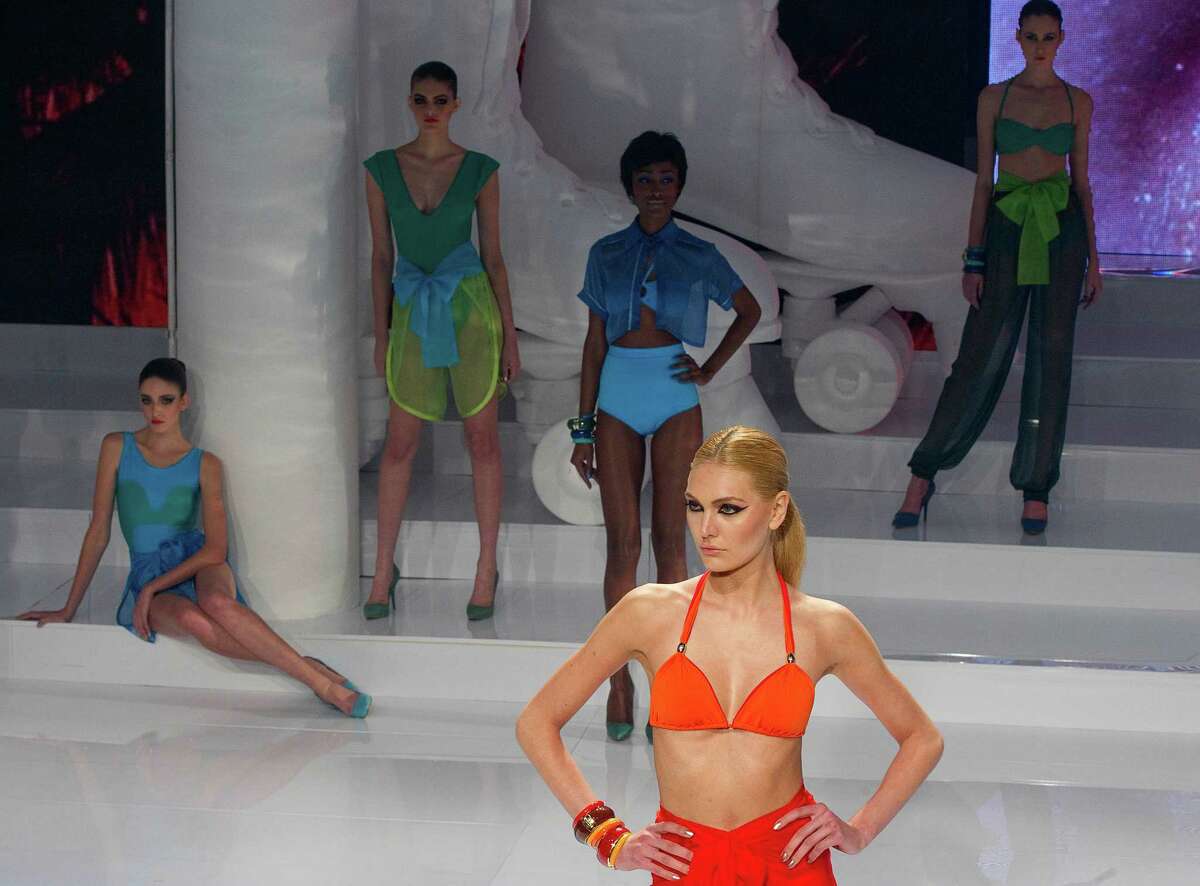 Models wear creations from the O Boticario summer collection during Sao Paulo Fashion Week events in Sao Paulo, Brazil, Wednesday, June 13, 2012. (AP Photo/Andre Penner)