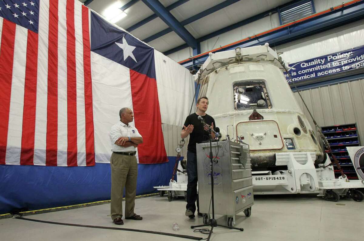 NASA Administrator Charles Bolden, left, and SpaceX CEO Elon Musk, right, stand in front of the SpaceX Dragon spacecraft Wednesday June 13, 2012 at the SpaceX Rocket Development Facility in McGregor, Texas. The spacecraft recently made history as the first commercial vehicle to visit the International Space Station. The California-based SpaceX is the first private business to send a cargo ship to the space station.