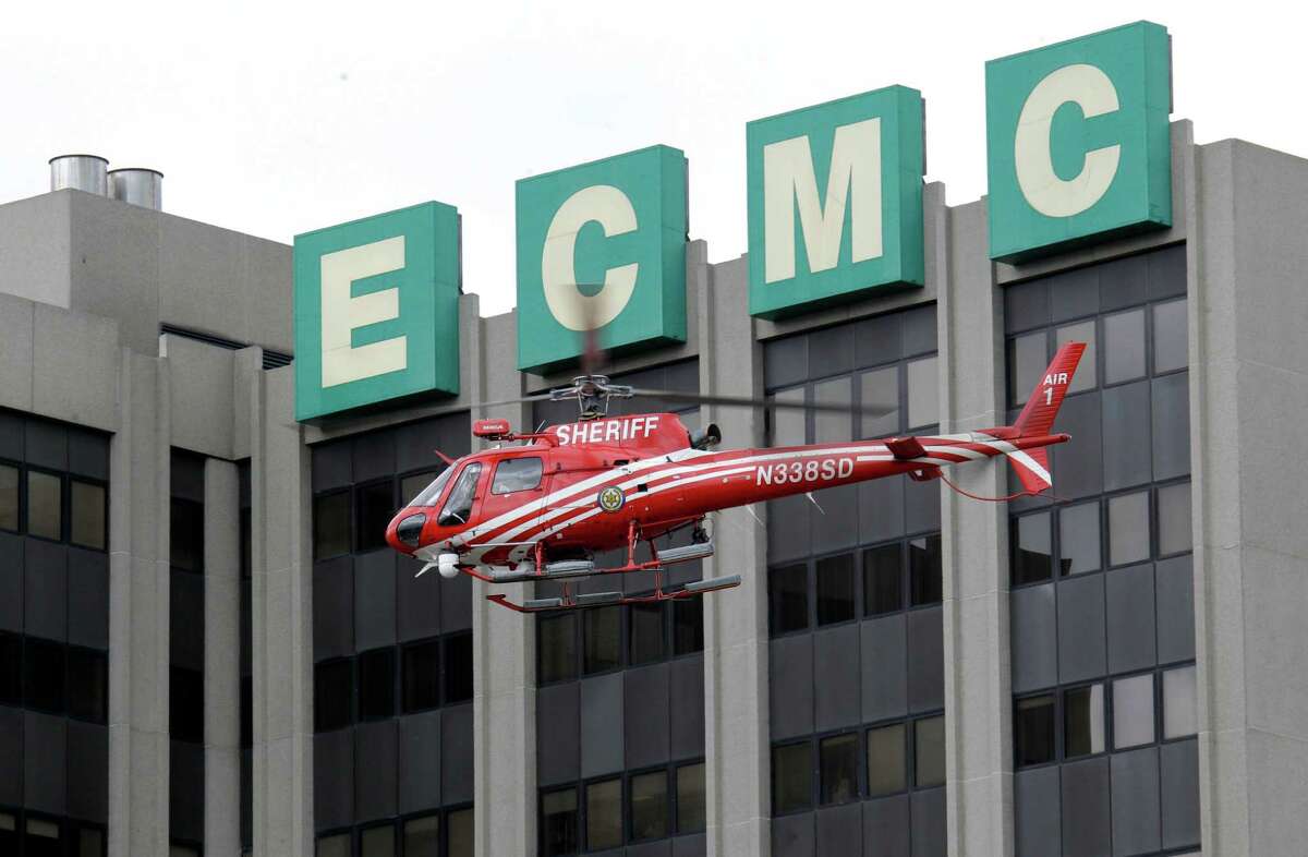 An Erie County Sheriff's helicopter searches at the scene of a shooting at Erie Count Medical Center in Buffalo, N.Y., Wednesday, June 13, 2012. A police official confirms that a woman was killed Wednesday morning on the grounds of the Erie County Medical Center, which he describes as being in "complete lockdown" as SWAT teams and other officers cordon off the 65-acre campus. (AP Photo/David Duprey)