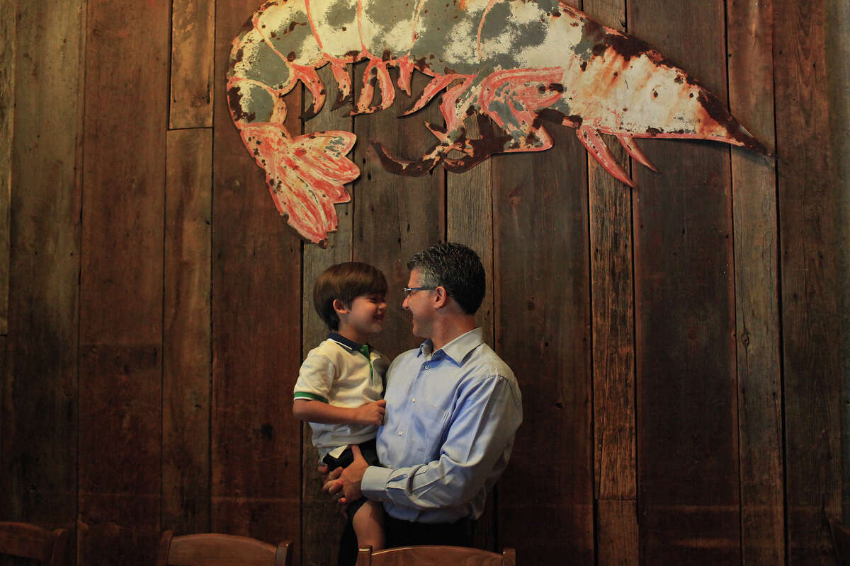Barclay Anthony talks with his son, Beau, 5, at their family's restaurant, Sea Island Shrimp House.