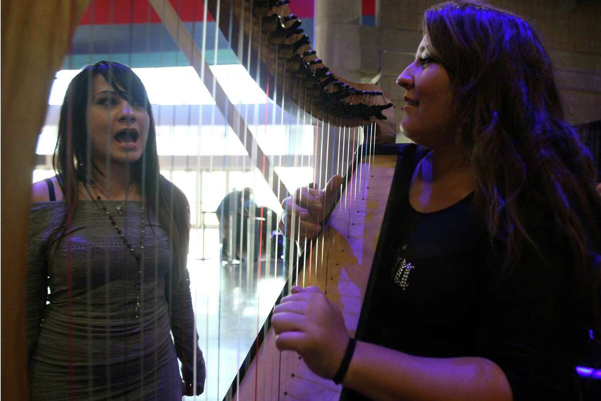 (From left) Chloe Loverock sings "Rolling in the Deep" by Adele while Kristen Smith plays the harp during the American Idol auditions Thursday June 14, 2012 at the Alamodome.