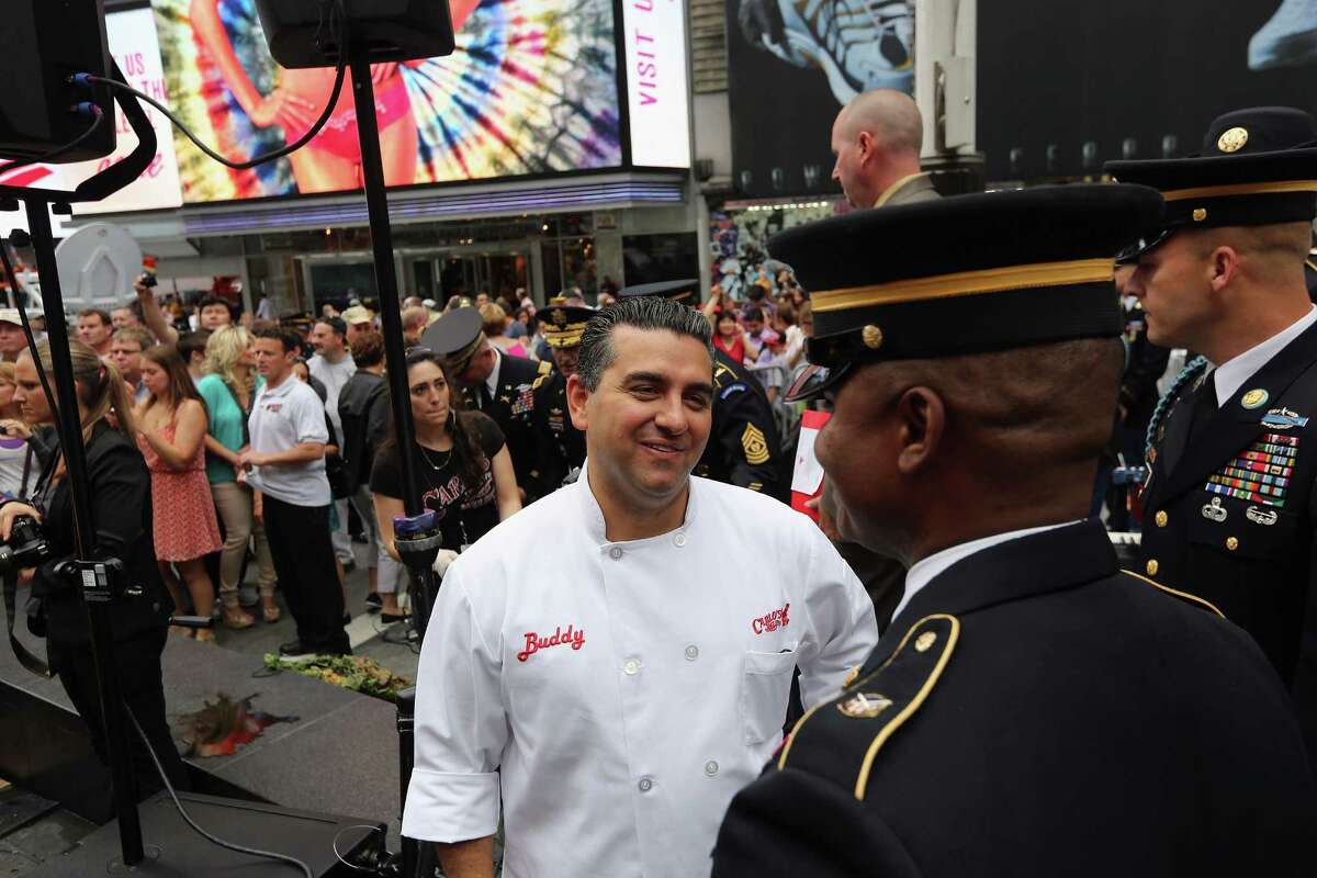NEW YORK, NY - JUNE 14: "Cake Boss" reality show baker Buddy Valastro thanks soldiers after attending a ceremony in Times Square marking the U.S. Army's 237th anniversary on June 14, 2012 in New York City. U.S. Army Chief of Staff Gen. Raymond Odierno cut Valastro's 500 pound cake before swearing in16 new recruits during the event. Valastro said eight of his staff spent three days preparing the giant cake in the shape of a tank.