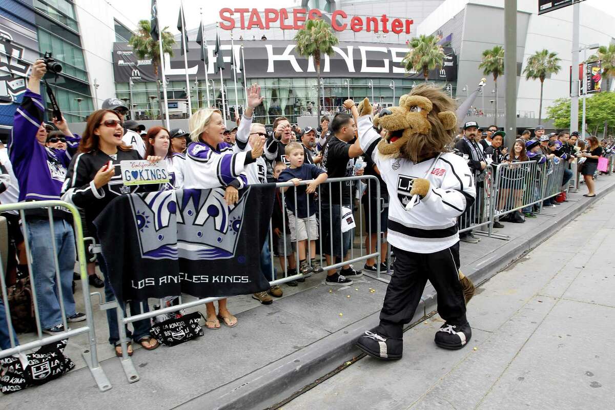Los Angeles Kings mascot Bailey high-fives the fans outside Staples Center before a parade celebrating the team's Stanley Cup win in Los Angeles, Thursday, June 14, 2012. (AP Photo/Jae C. Hong)