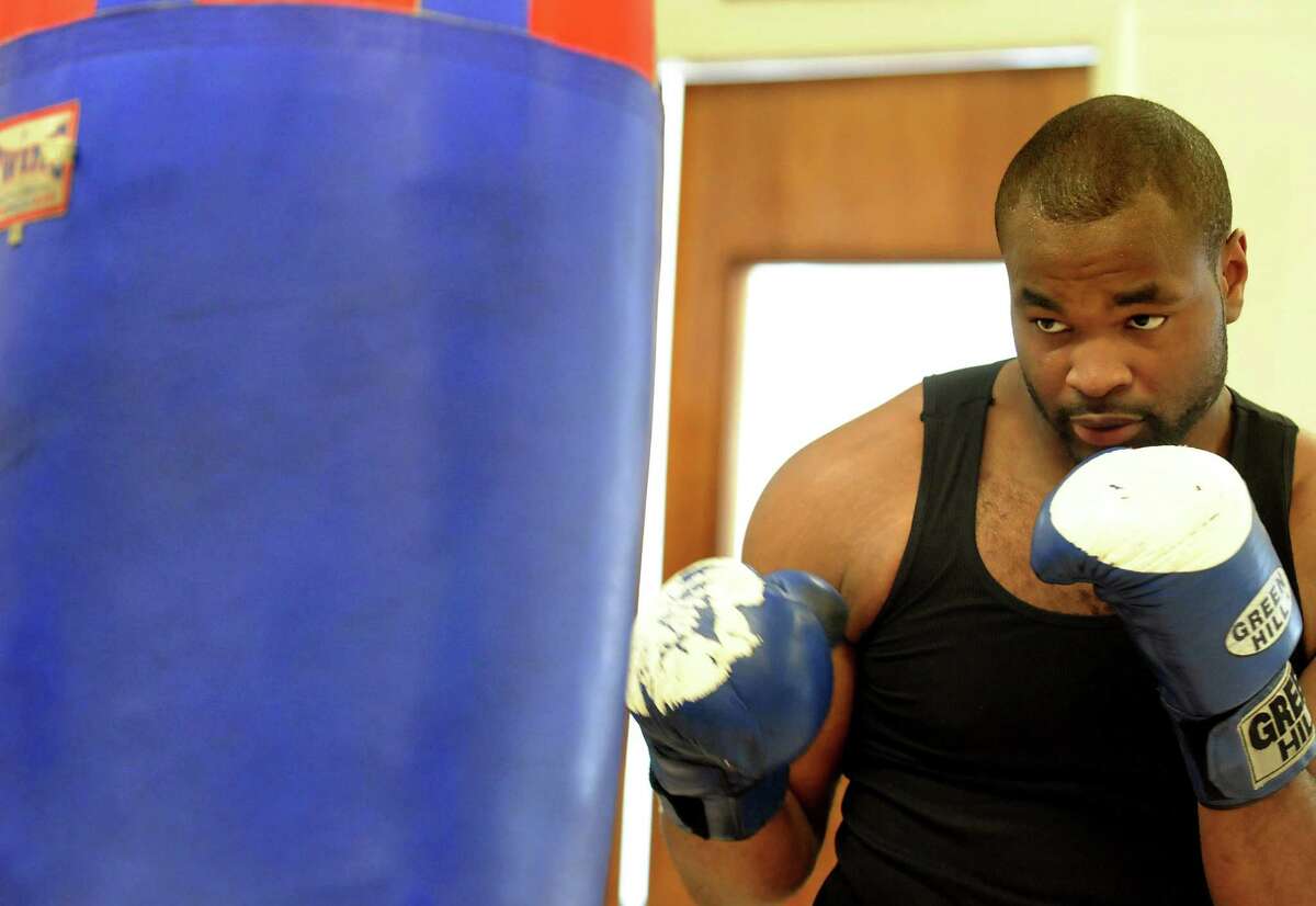 Boxer Kimdo Bethel (cq) hits the bag on Thursday, July 9, 2009, at Albany Boxing Club in Albany, N.Y. Bethel will make his professional debut on Aug. 7 in Troy. (Cindy Schultz / Times Union)