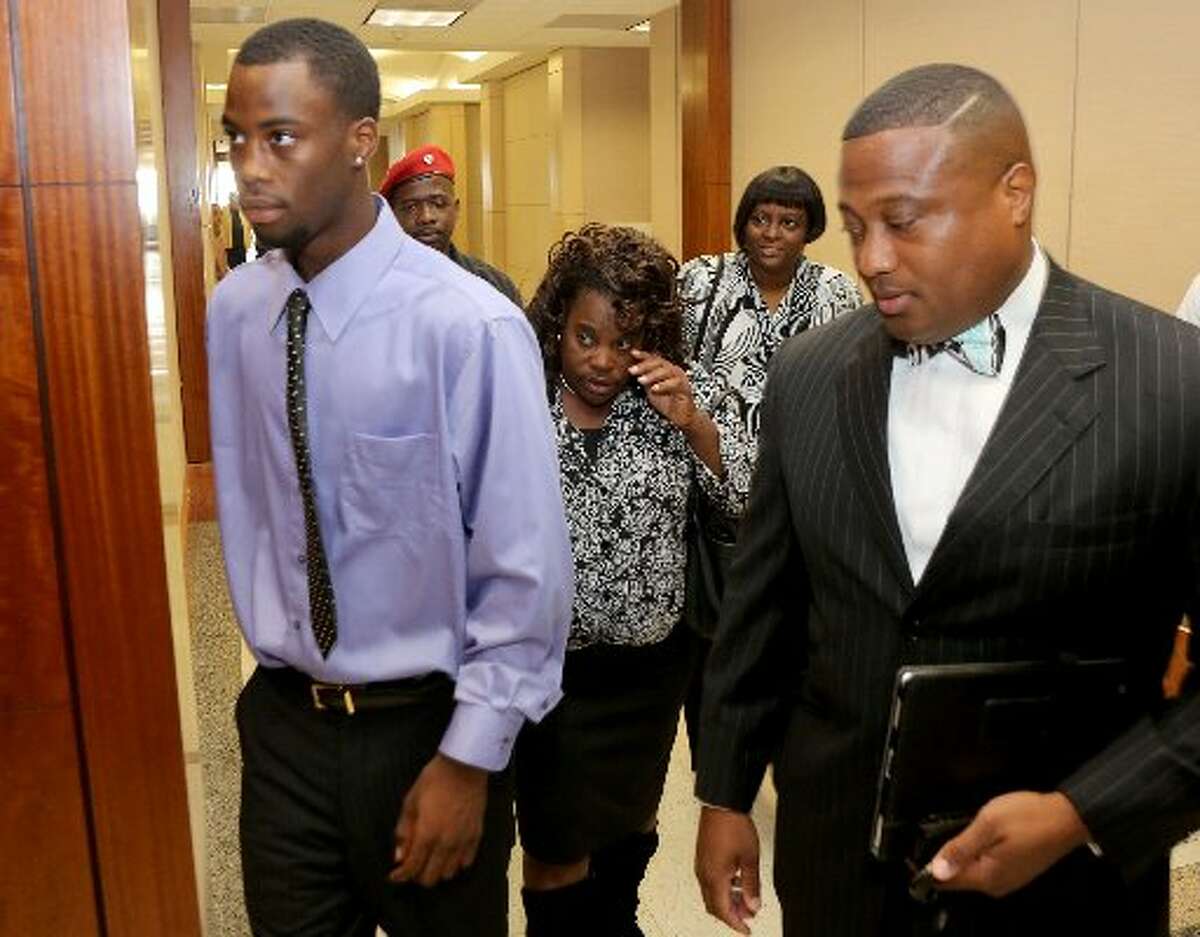 Chad Holley, with his mother Joyce Holley and Quanell X enters the 178th court in Houston, Texas, on Friday, June 15. (Thomas B. Shea / For the Chronicle )