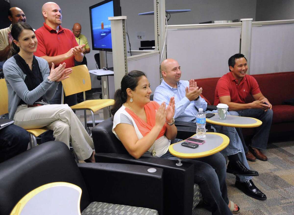 USAA has relaxed its dress code to allow employees, such as those shown in this 2012 photo, to don shorts as long as they don't have face-to-face contact with customers or visitors. Under the revised code, workers also can sport sandals with a heal strap and tennis shoes. (Express-News file photo)